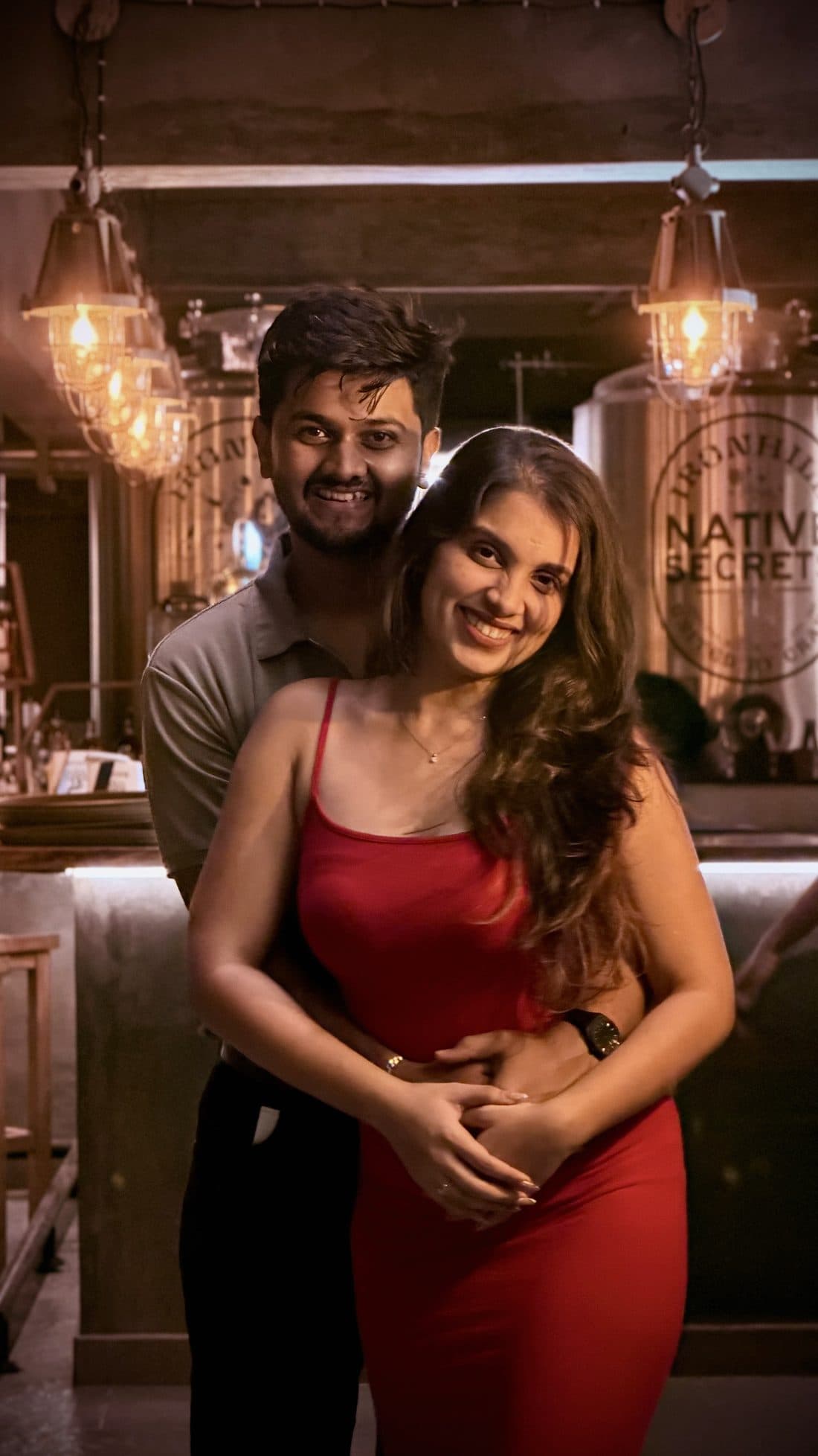 Sudhanva holding Sneha in a warmly lit café